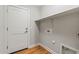 Laundry room featuring floating shelf, textured walls, and wood flooring at 6843 S 46Th Dr, Laveen, AZ 85339