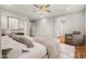 Comfortable main bedroom featuring a ceiling fan, a chair, and wood-look floors at 6843 S 46Th Dr, Laveen, AZ 85339