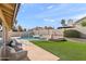 This backyard retreat features a sparkling pool and spa surrounded by lush artificial turf, perfect for outdoor entertaining at 7108 W Corrine Dr, Peoria, AZ 85381