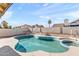 Backyard with a sparkling pool and spa, surrounded by artificial grass and a concrete patio at 7108 W Corrine Dr, Peoria, AZ 85381