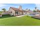 Expansive backyard featuring lush artificial turf, a sparkling pool, and a cozy patio for outdoor gatherings at 7108 W Corrine Dr, Peoria, AZ 85381
