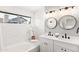 Bright bathroom with white subway tile, dual sinks, and modern fixtures at 7108 W Corrine Dr, Peoria, AZ 85381