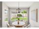 Dining area boasts an oversized window view of the lush backyard and modern light fixture at 7108 W Corrine Dr, Peoria, AZ 85381