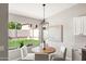 Eat-in kitchen boasts views of the backyard and a modern light fixture at 7108 W Corrine Dr, Peoria, AZ 85381