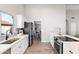 Open-concept kitchen featuring stainless appliances, white cabinets, and sight lines to the living room at 7108 W Corrine Dr, Peoria, AZ 85381
