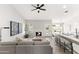 Inviting living room with fireplace, modern decor, and open layout to the kitchen at 7108 W Corrine Dr, Peoria, AZ 85381