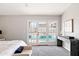 The primary bedroom has backyard views and a modern console table at 7108 W Corrine Dr, Peoria, AZ 85381