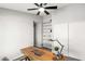 Bright office featuring a built-in shelving unit and a wooden desk at 7108 W Corrine Dr, Peoria, AZ 85381