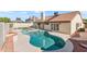 Inviting backyard pool with spa surrounded by patio and desert landscaping, perfect for relaxation and entertaining at 7108 W Corrine Dr, Peoria, AZ 85381