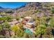 An aerial view of a desert estate showcasing a sparkling pool, lush landscaping, and red tile roof at 7131 N 40Th St, Paradise Valley, AZ 85253