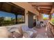 Covered outdoor balcony featuring a fireplace, ceiling fans, and comfortable seating with mountain views at 7131 N 40Th St, Paradise Valley, AZ 85253
