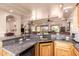Home bar with a granite countertop and wood cabinetry, including a bar tap and mini fridge at 7131 N 40Th St, Paradise Valley, AZ 85253