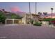 Exterior evening shot featuring the home's garage, terracotta roofing, desert landscaping and large brick driveway at 7131 N 40Th St, Paradise Valley, AZ 85253