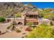 Stunning home with desert landscaping, red tile roof, an archway, and a balcony offering scenic views at 7131 N 40Th St, Paradise Valley, AZ 85253