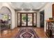 Stunning foyer with detailed iron double doors, tile flooring, brick accents, and elegant rug at 7131 N 40Th St, Paradise Valley, AZ 85253