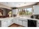 Spacious kitchen featuring white cabinets, neutral countertops, and a picturesque view of desert scenery at 7131 N 40Th St, Paradise Valley, AZ 85253