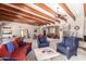 Bright living room with wooden beam ceiling, comfortable seating, and views into adjoining rooms at 7131 N 40Th St, Paradise Valley, AZ 85253