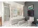 Bright bathroom with a tiled shower, tub, toilet, and plantation shutters on the windows at 7131 N 40Th St, Paradise Valley, AZ 85253