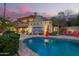 Tranquil pool area at dusk, reflecting the home's architecture and the serene mountain backdrop at 7131 N 40Th St, Paradise Valley, AZ 85253