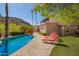 Backyard pool area with comfortable lounge seating and lush landscaping, ideal for relaxation and entertainment at 7131 N 40Th St, Paradise Valley, AZ 85253