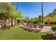 Inviting pool area with ample lounge chairs on artificial turf, creating a perfect outdoor retreat at 7131 N 40Th St, Paradise Valley, AZ 85253