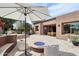 Expansive backyard featuring a luxurious pool, dining area, outdoor seating, a fire pit and desert landscaping at 7169 E Bramble Berry Ln, Scottsdale, AZ 85266
