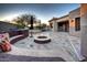 Beautiful backyard with a cozy sitting area, fire pit, and lush landscaping, perfect for outdoor living at 7169 E Bramble Berry Ln, Scottsdale, AZ 85266