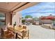 Stunning backyard featuring a pool, dining area, outdoor kitchen, a fire pit, and desert landscaping at 7169 E Bramble Berry Ln, Scottsdale, AZ 85266