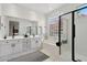 Elegant bathroom with double vanity, tub, glass block window, and walk-in shower at 7169 E Bramble Berry Ln, Scottsdale, AZ 85266