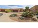 Single-level home's exterior is landscaped with native desert plants and trees at 7169 E Bramble Berry Ln, Scottsdale, AZ 85266