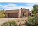 Single-level home with desert landscaping, a two-car garage, and tile roof at 7169 E Bramble Berry Ln, Scottsdale, AZ 85266