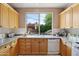 Well-lit kitchen area showcasing wood cabinets and a large window overlooking the pool at 7169 E Bramble Berry Ln, Scottsdale, AZ 85266