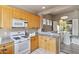 Bright kitchen with light wood cabinets, tiled floors, and neutral countertops at 7169 E Bramble Berry Ln, Scottsdale, AZ 85266