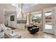 Spacious living area with high ceilings, a fireplace, and access to the patio at 7169 E Bramble Berry Ln, Scottsdale, AZ 85266