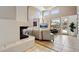 Spacious living room featuring a fireplace and large windows with views of the patio at 7169 E Bramble Berry Ln, Scottsdale, AZ 85266