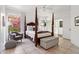 Bedroom with four-post bed, cozy chair, and large windows at 7169 E Bramble Berry Ln, Scottsdale, AZ 85266