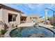 Inviting backyard pool with lush landscaping, an umbrella and lounge seating for relaxation and outdoor enjoyment at 7169 E Bramble Berry Ln, Scottsdale, AZ 85266