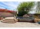 Inviting backyard pool and spa area with lush desert landscaping and rock waterfall feature at 7169 E Bramble Berry Ln, Scottsdale, AZ 85266