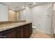 This bathroom features a modern sink and granite countertop with tiled shower behind the toilet at 7175 E Camelback Rd # 510, Scottsdale, AZ 85251