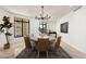 This elegant dining room features a modern chandelier and a large window at 7175 E Camelback Rd # 510, Scottsdale, AZ 85251