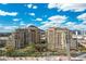 Stunning exterior view of two high-rise residential buildings with lush landscaping and the Arizona Canal at 7175 E Camelback Rd # 510, Scottsdale, AZ 85251