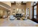 Elegant foyer features marble floors, a grand chandelier, and a cozy seating area with a fireplace at 7175 E Camelback Rd # 510, Scottsdale, AZ 85251