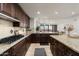 Open concept kitchen with granite countertops, gas cooktop, and views into living area at 7175 E Camelback Rd # 510, Scottsdale, AZ 85251