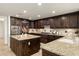 Spacious kitchen featuring granite countertops, a large island, and dark wood cabinetry at 7175 E Camelback Rd # 510, Scottsdale, AZ 85251