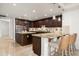 Gourmet kitchen with granite countertops, dark wood cabinets, and stainless steel appliances at 7175 E Camelback Rd # 510, Scottsdale, AZ 85251