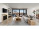Bright living room with fireplace, large windows with balcony access and neutral color palette at 7175 E Camelback Rd # 510, Scottsdale, AZ 85251