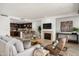 This bright living room features a fireplace and comfortable seating, with an open kitchen behind at 7175 E Camelback Rd # 510, Scottsdale, AZ 85251