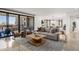 Open-concept living room with balcony, neutral furniture, and views to the dining area at 7175 E Camelback Rd # 510, Scottsdale, AZ 85251