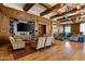 Inviting living room showcasing wood-paneled walls, built-in shelving, a fireplace, and hardwood floors at 7175 E Camelback Rd # 510, Scottsdale, AZ 85251