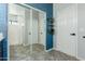 Well-lit bathroom featuring a modern design with gray tile flooring, a blue accent wall, and a large mirror over the vanity at 7204 S Golfside Ln, Phoenix, AZ 85042